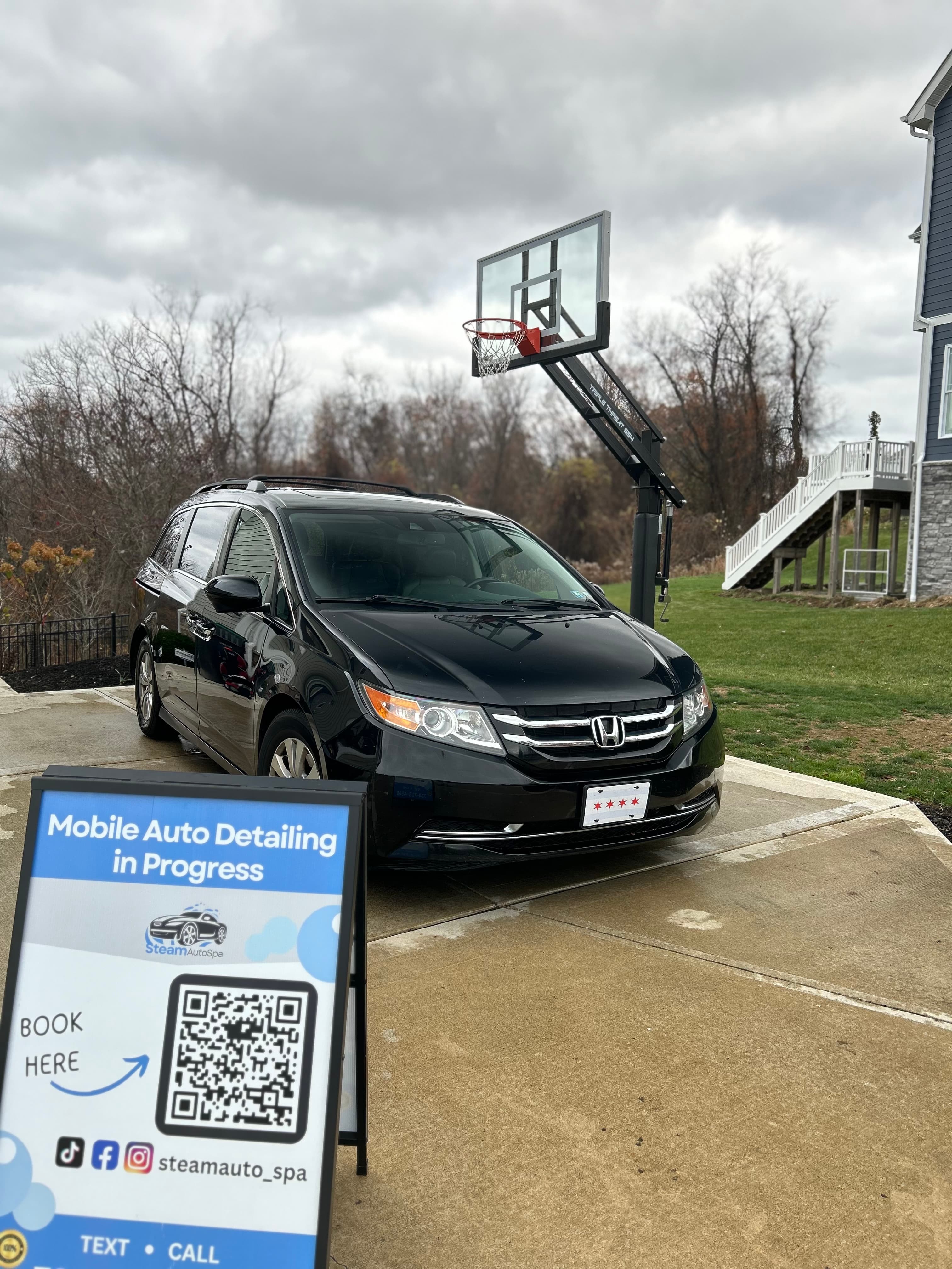 Steam Auto Spa detailing an Odyssey on-site in a customer's driveway